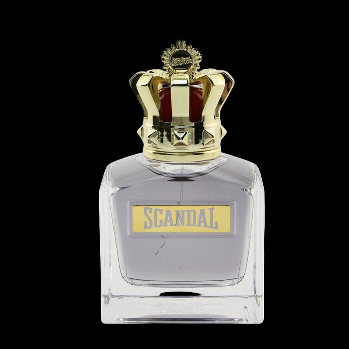 Perfume bottle with gold cap labeled 'Scandal' on a white background
