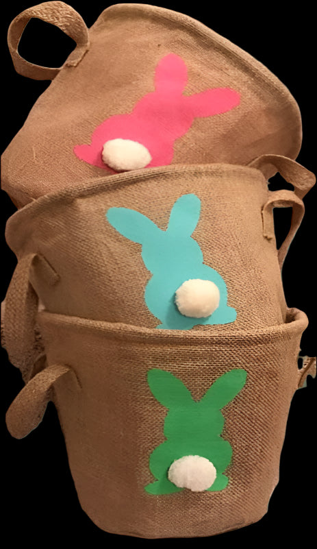 Three brown Easter baskets with colorful bunny designs on a carpeted staircase.