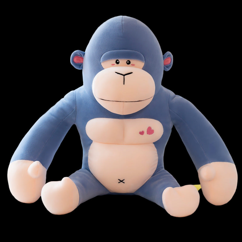 Blue monkey plush toy on a white surface with a blurred background