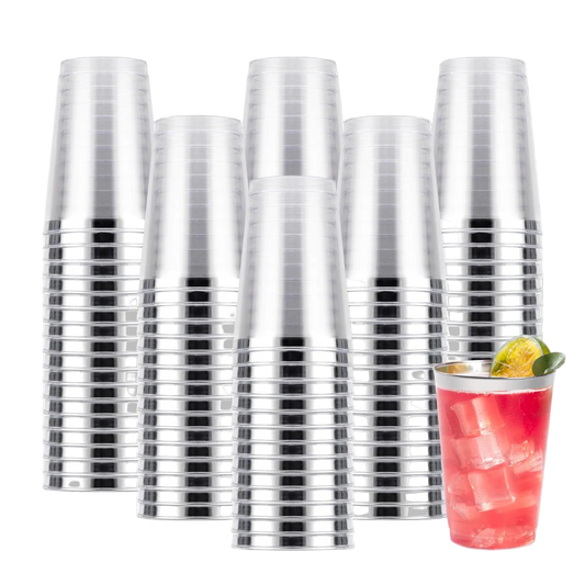 Stack of clear plastic cups with a cocktail in the foreground on a white background