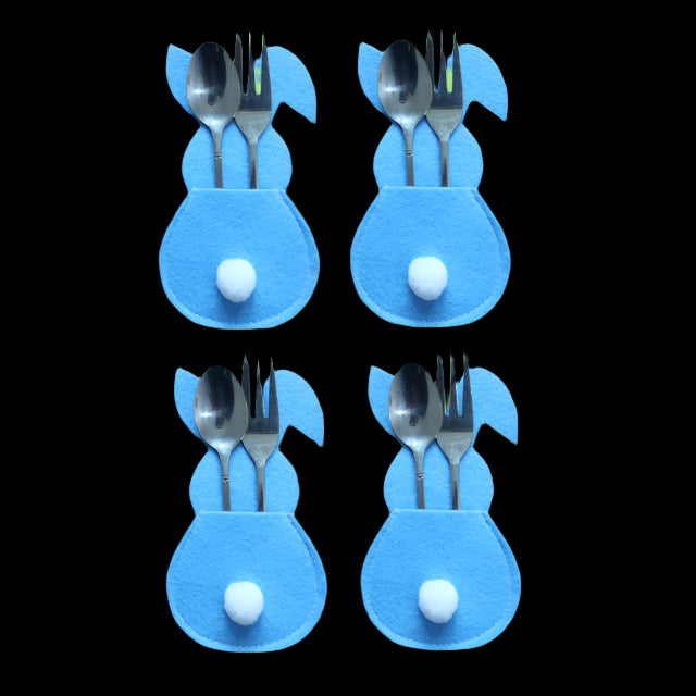 Four blue bunny-shaped cutlery holders with spoons and forks on a white background