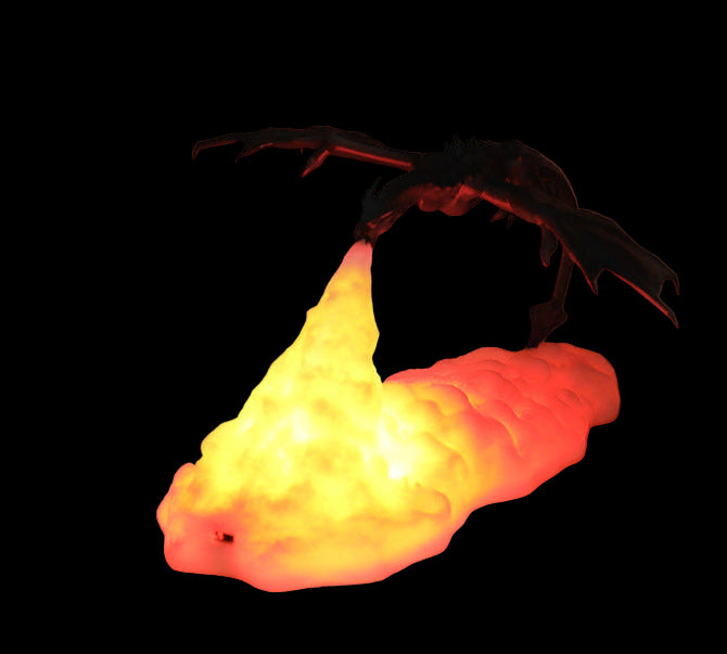 Decorative lamp shaped like a dragon with a glowing yellow base on a table.