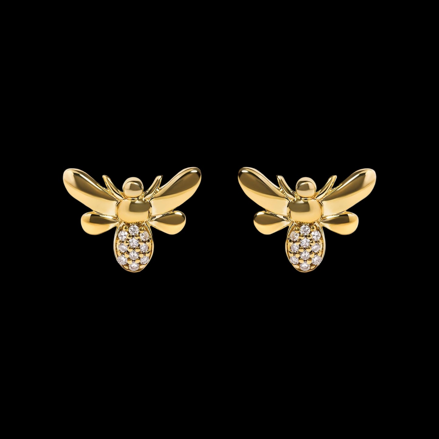 Gold bee-shaped earrings with embedded stones on a white background