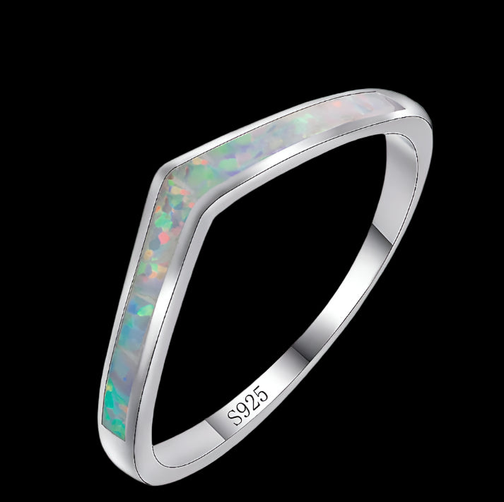 Silver ring with opal inlay on a white background