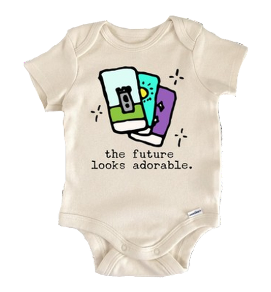 Beige baby onesie with colorful graphic and text 'the future looks adorable' on a white background