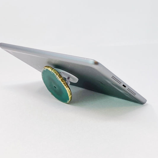 Phone stand with green circular base on a white background