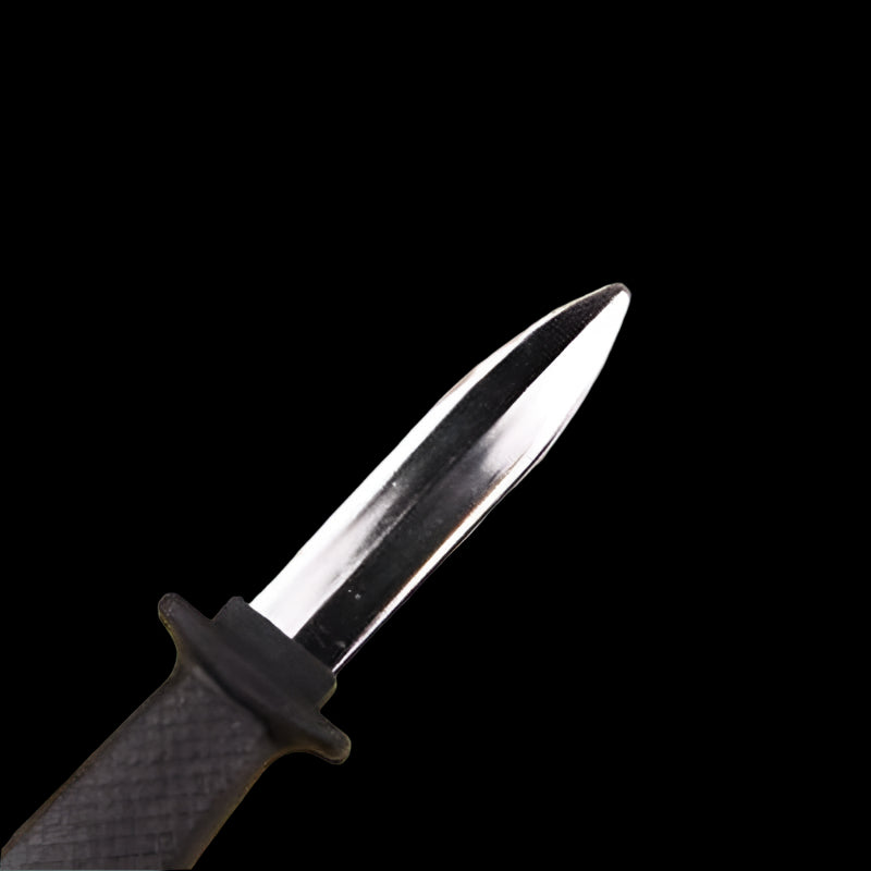 Knife with a black handle on a yellow surface with flowers in the background