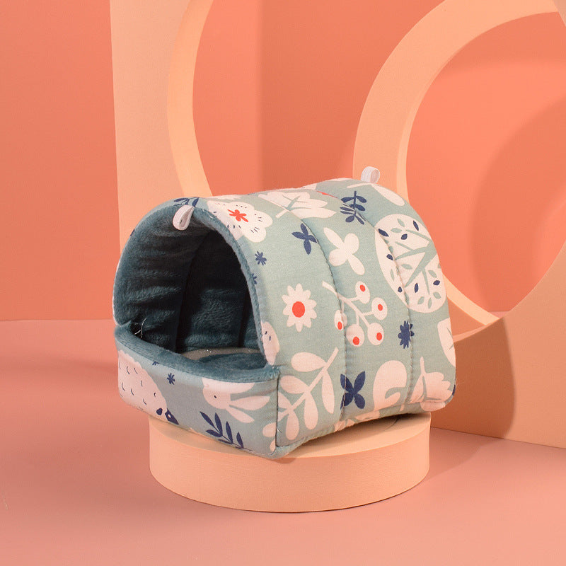 Floral-patterned pet bed on a pink stand with a pink background