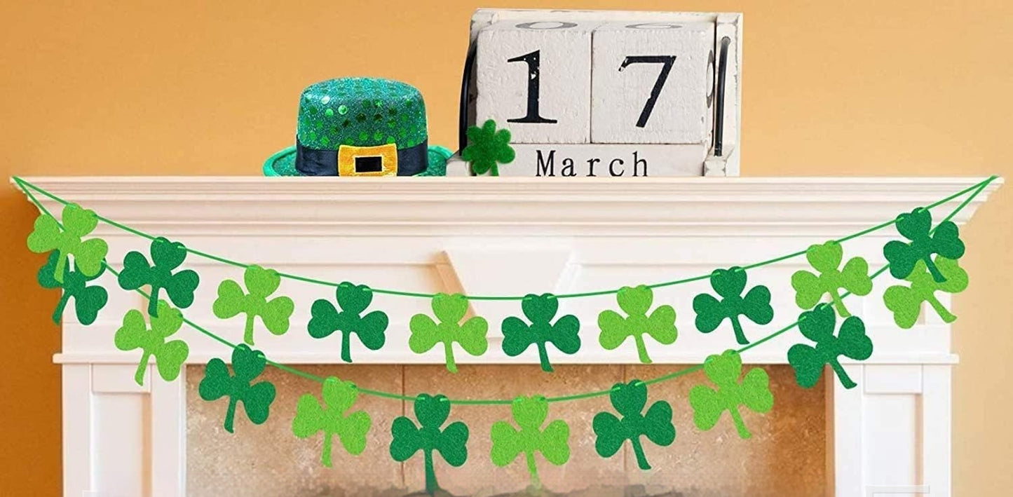 Green shamrock garland on a fireplace mantel with a calendar displaying March 17th.