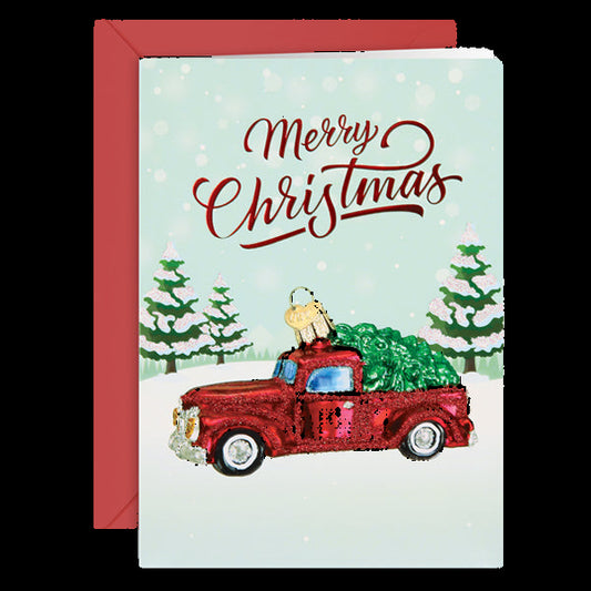 Christmas card with a red truck carrying a Christmas tree and 'Merry Christmas' text.
