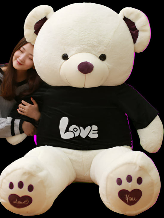 Person hugging a large white teddy bear with a black shirt in a room with bookshelves.