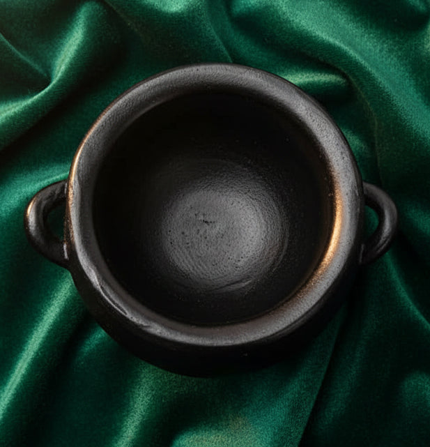 Black pot with handles on a white background