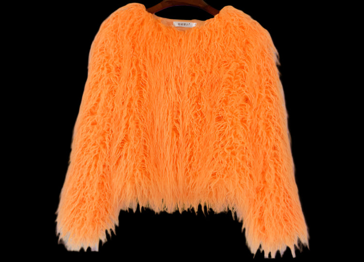 Orange fluffy sweater on a hanger against a gray wooden panel background