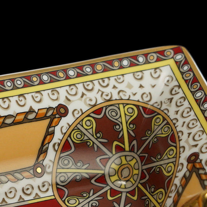 Decorative tray with intricate patterns and colors on a dark background