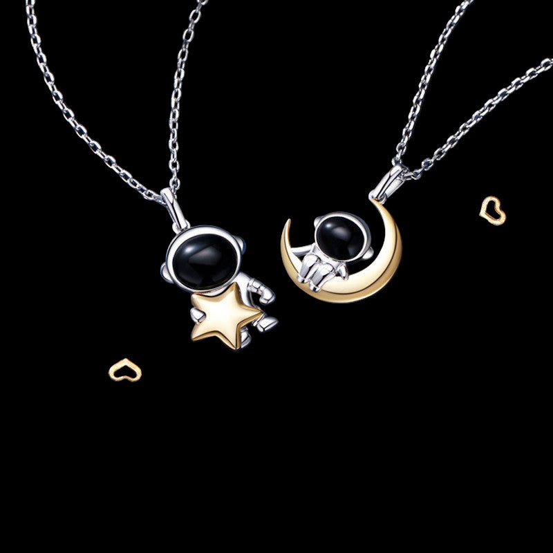 Two necklaces with black gemstones on a blue background