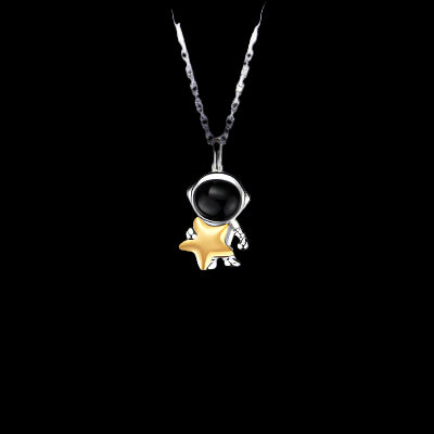 Necklace with a black gemstone and gold star pendant on a white background