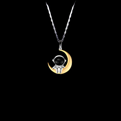 Necklace with a crescent moon and black stone pendant on a white background