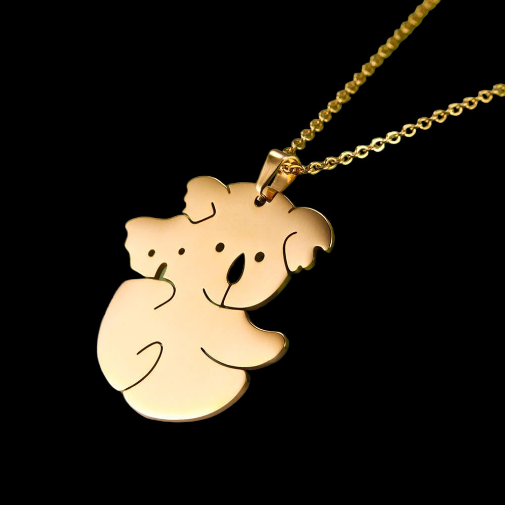 Gold koala pendant necklace on a green and gray background