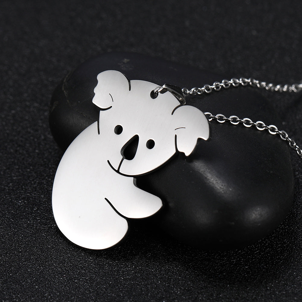 silver koala bear pendant on a chain against a dark background