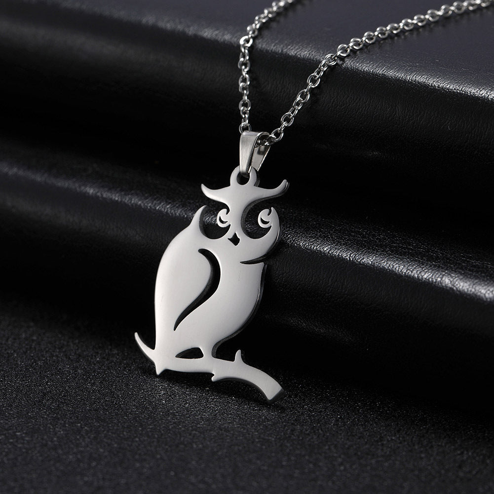 Silver owl pendant necklace on a black background