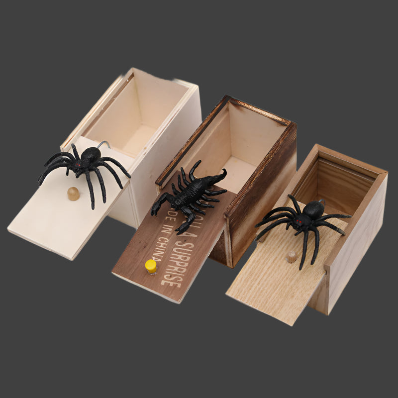 Wooden boxes with fake spiders on a white background