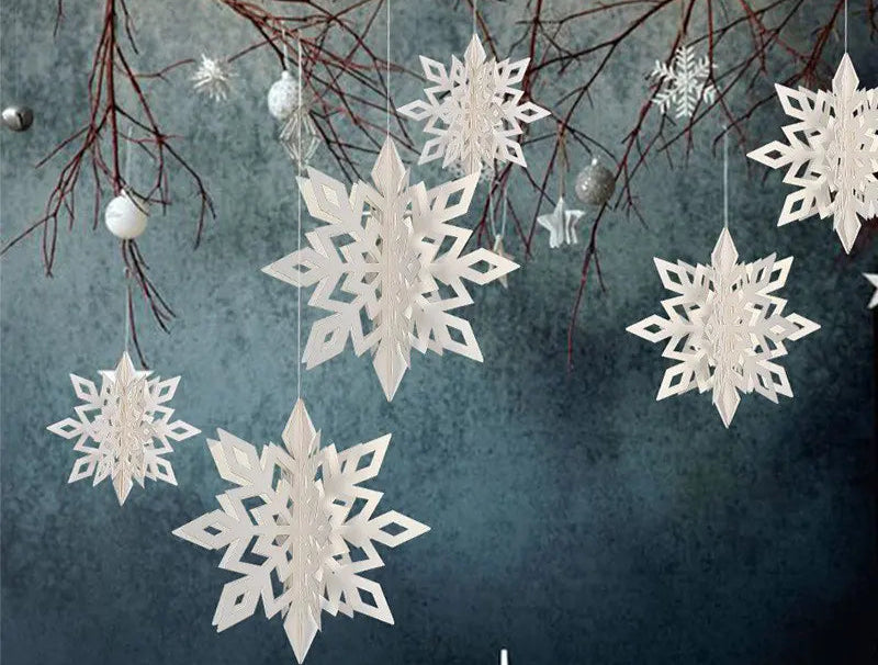 White snowflake ornaments hanging from branches against a textured blue background
