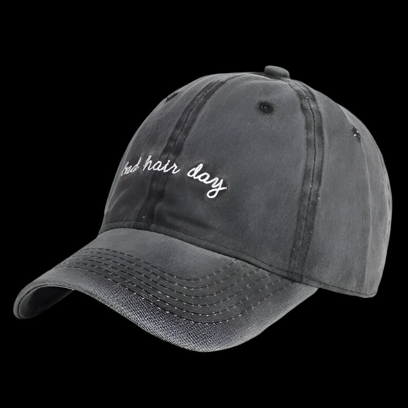 Gray cap with 'bad hair day' text on a purple background