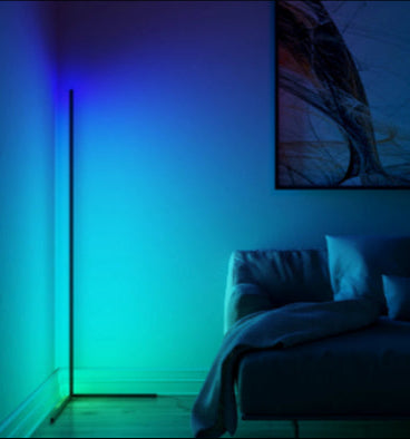 Modern bedroom with a floor lamp emitting blue light and abstract art on the wall.