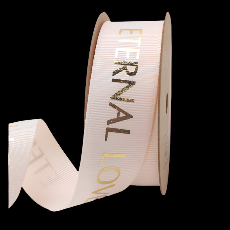 Spool of ribbon with 'Eternal Love' text on a white background