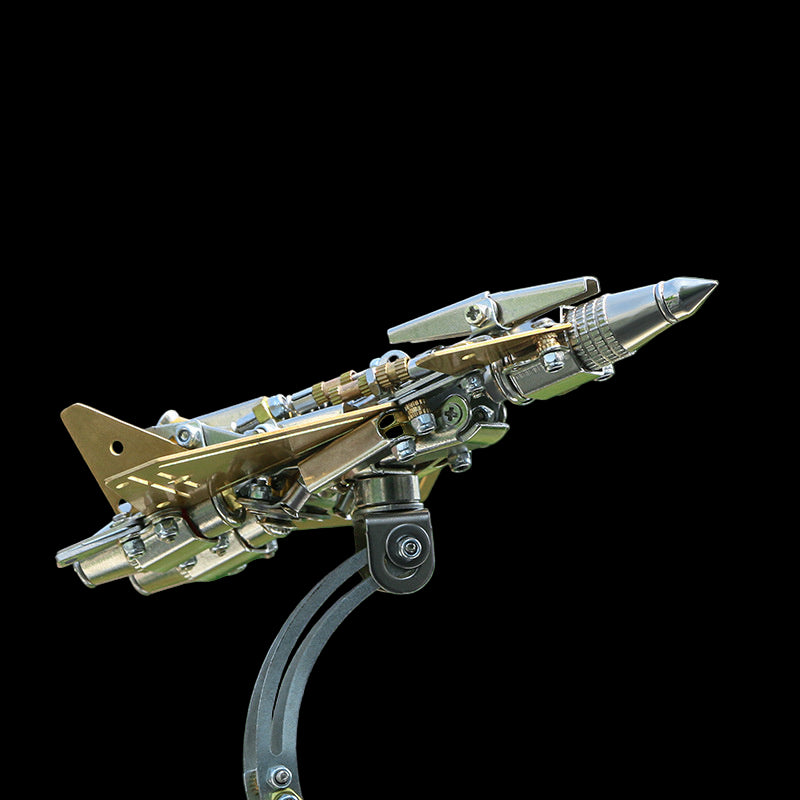 Metallic model of a fighter jet on a stand with a blurred green background
