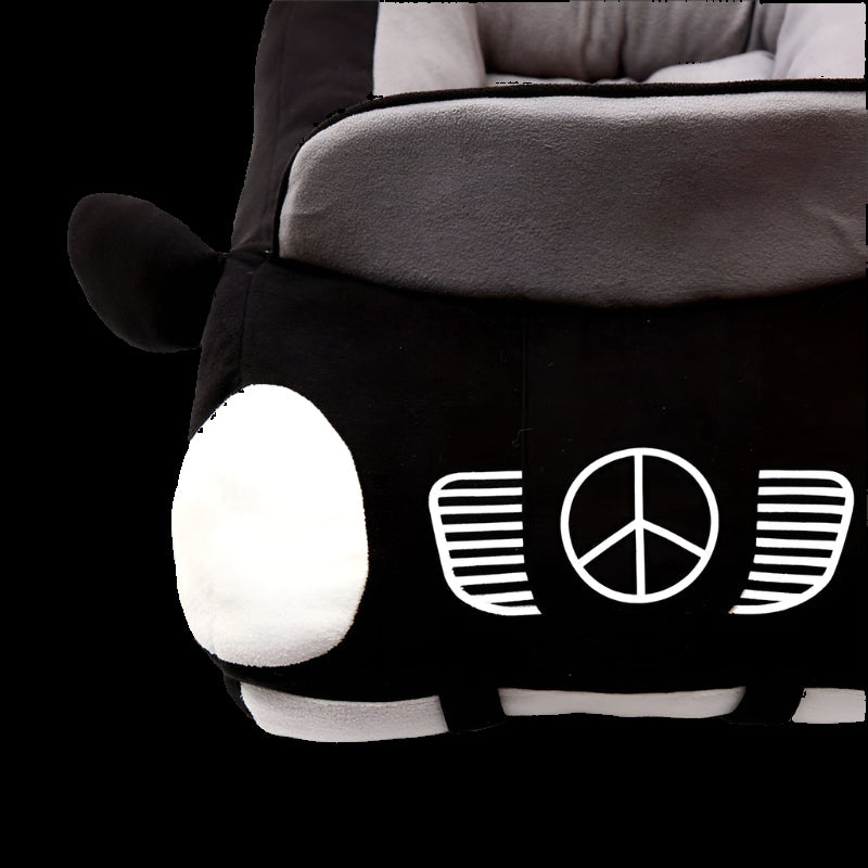 Black and gray plush toy with peace symbol design on a white background