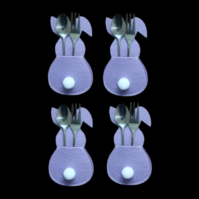 Four purple bunny-shaped cutlery holders with spoons and forks on a white background