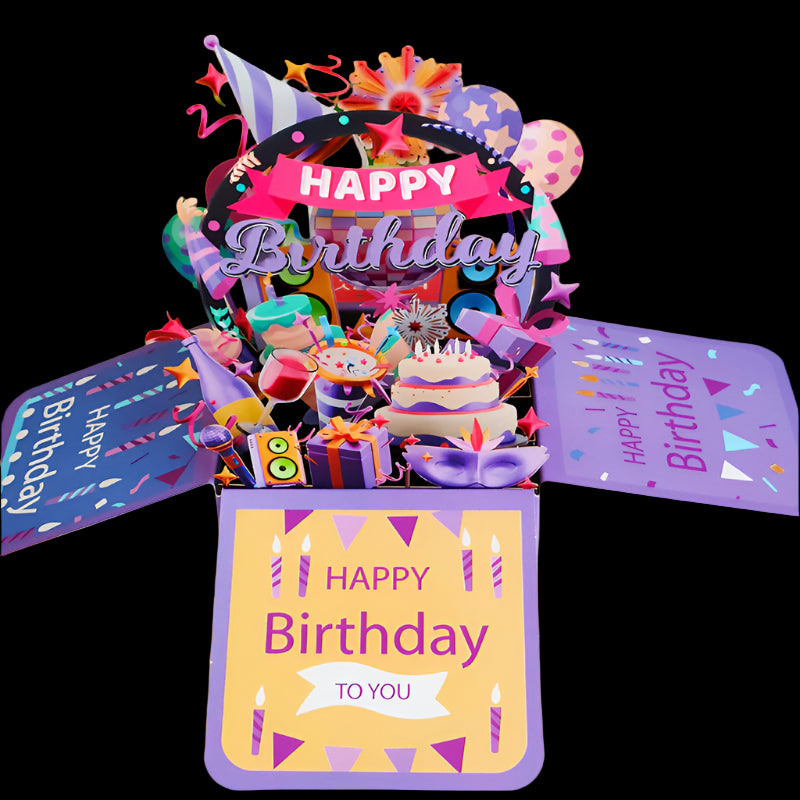 Colorful birthday pop-up card with cake and balloons in a box, surrounded by plants.