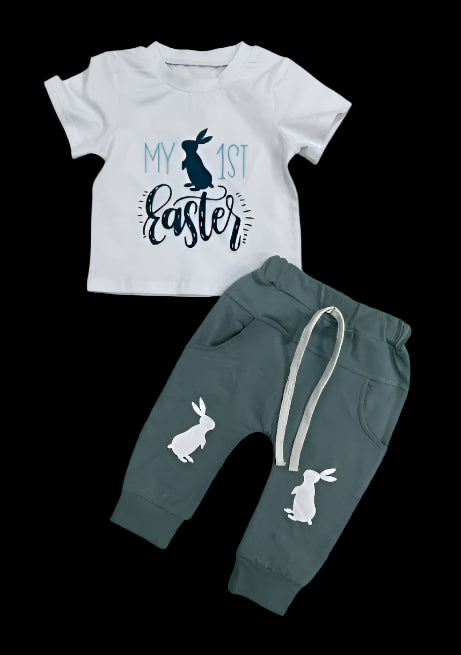 Children's outfit with white shirt and green pants on a tiled floor