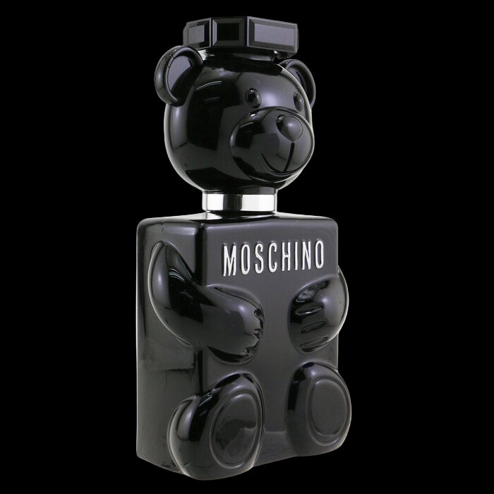 Black perfume bottle shaped like a bear with 'Moschino' branding on a white background