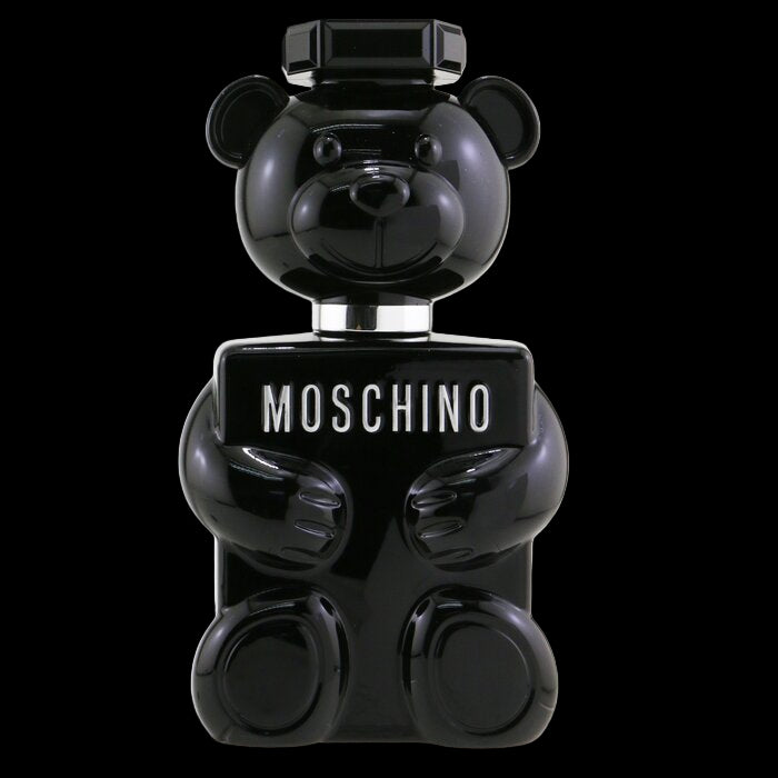 Black bear-shaped Moschino perfume bottle on a white background