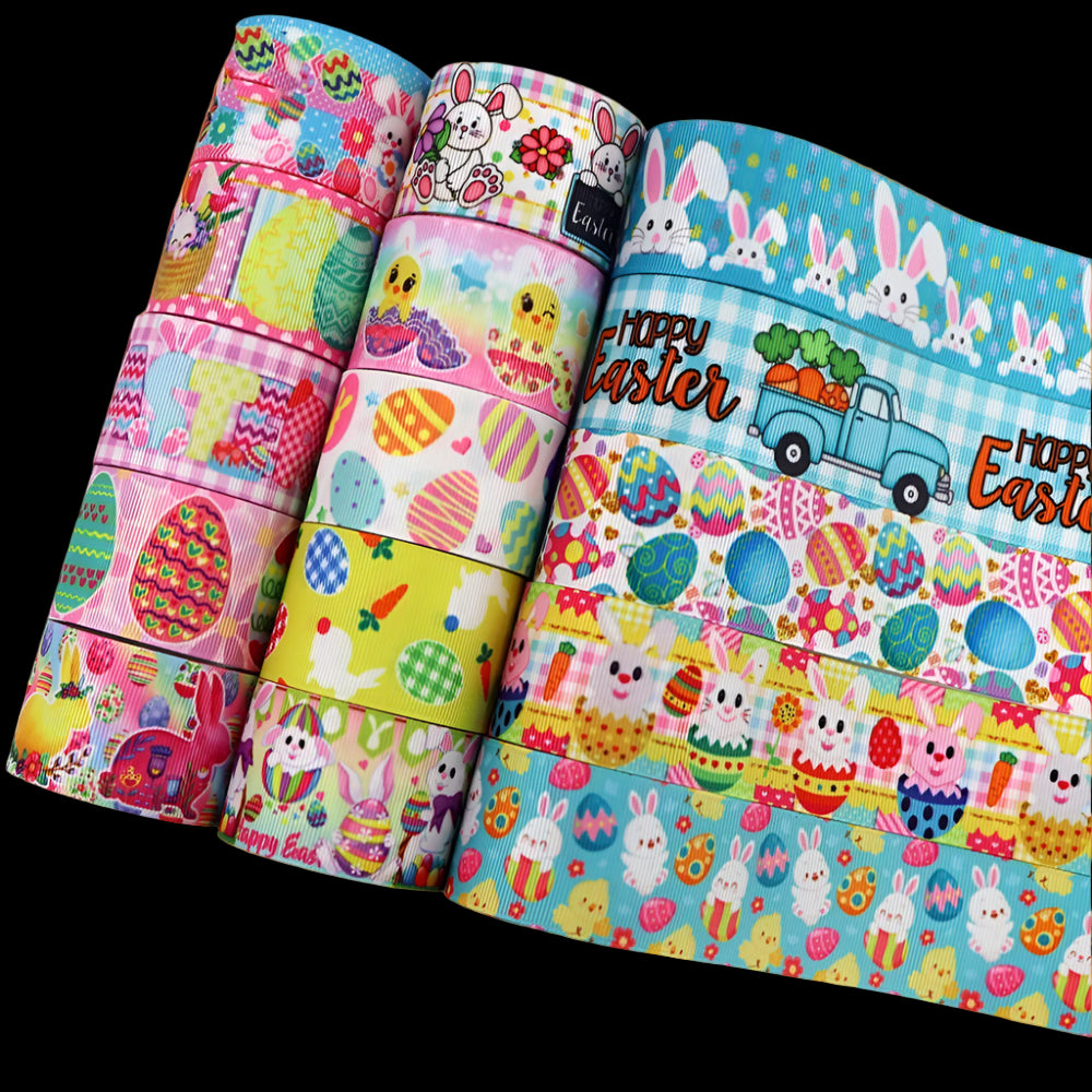 Three rolls of Easter-themed fabric with colorful patterns on a white background