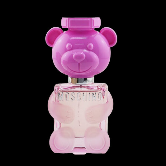 Pink teddy bear-shaped Moschino perfume bottle on a white background