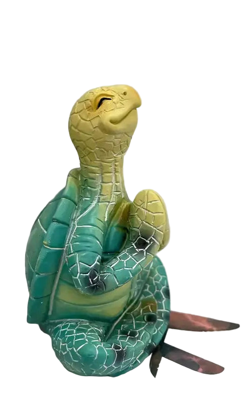Toy turtle with a yellow head and green body on a white surface.