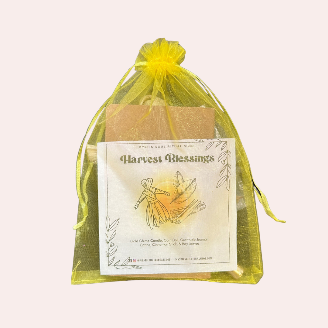Harvest Blessings candle in a yellow organdy bag on a light pink background