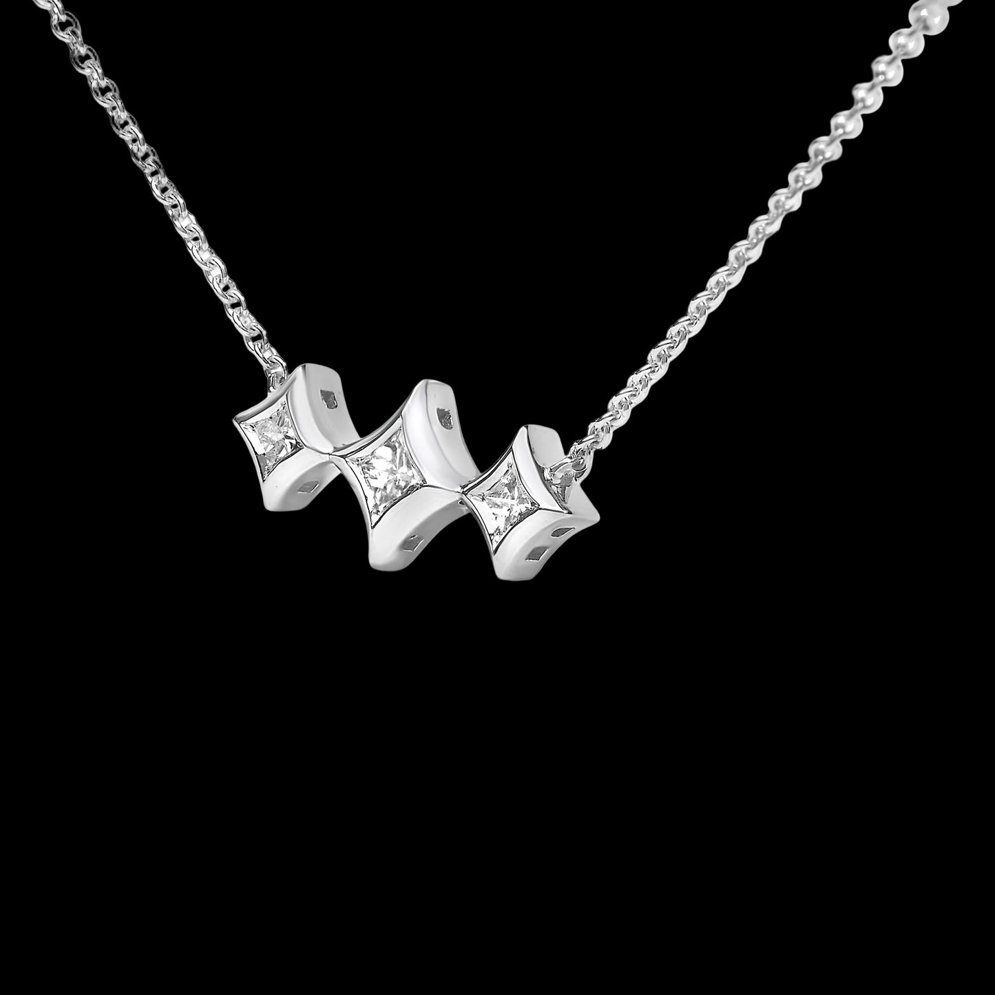 Silver necklace with a star-shaped pendant on a white background