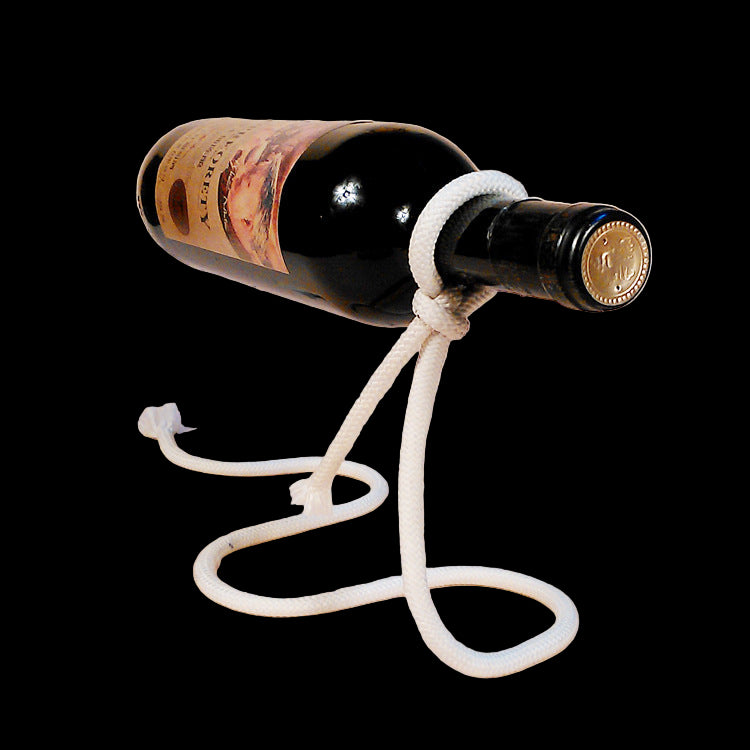 Wine bottle with a rope stand on a plain background