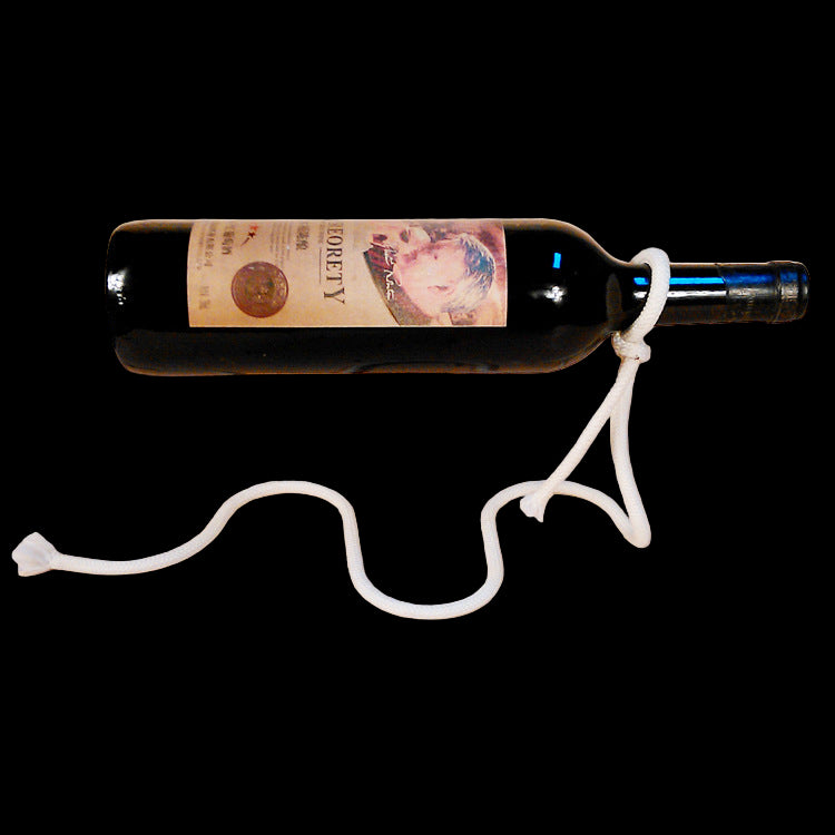Wine bottle with a label tied to it on a beige background