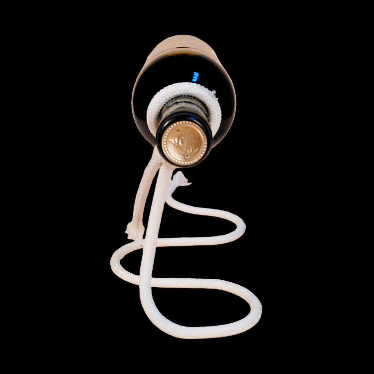Bottle with a white rope attached on a beige background