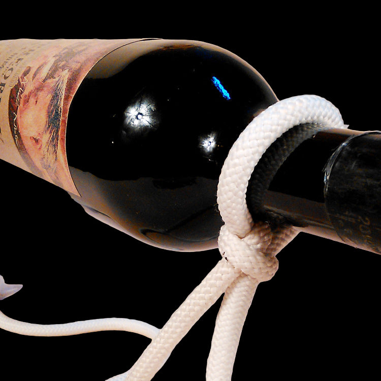 Wine bottle with a rope tied around it on a beige background