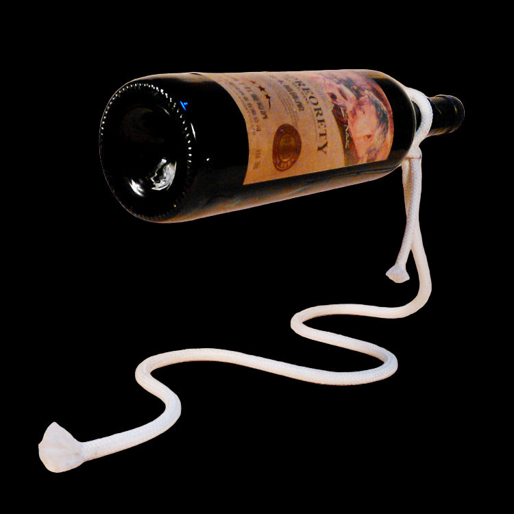 Wine bottle with a white cable attached on a beige background