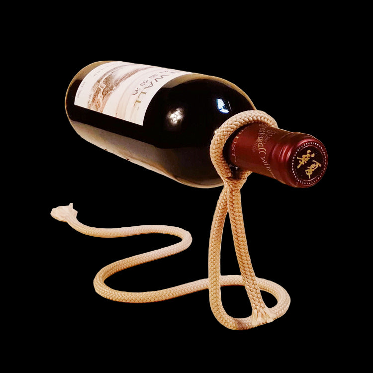 Wine bottle with a rope attached on a beige background