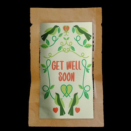 Get well soon card with green birds and hearts on a wooden surface