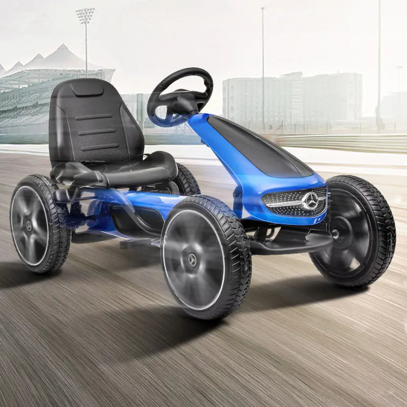 Blue children's go-kart with Mercedes-Benz logo on a wooden floor.