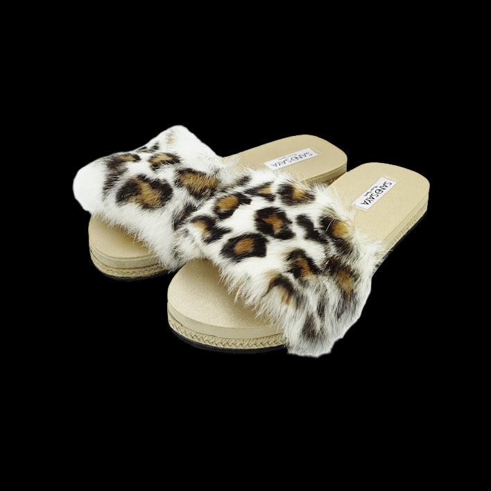 Pair of leopard print fur slides on a white background